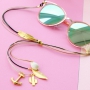 Summer proof: sunglasses cords with golden details and minimalist earrings