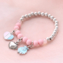Girly jewellery with cheerful metal charms and soft colours