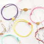 Need some inspiration? It's easy to make trendy bracelets out of elastic cord: