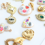 Create a funky charm necklace with metal charms with enamel
