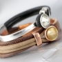Nice stitched leather with beautiful findings and charms made of Designer Quality metal!