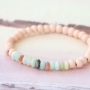 Beautiful semi-precious stone bracelets in soft colours mixed with wooden beads, cork, tassels and DQ metal charms.